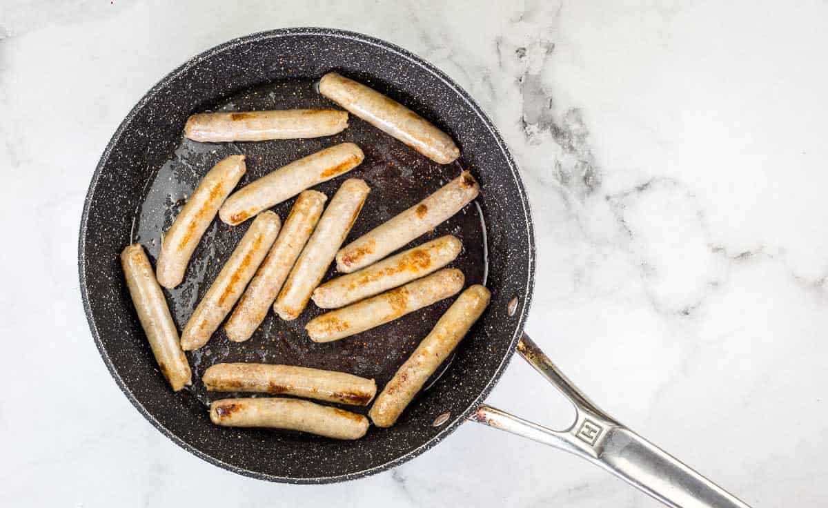 Browned sausage in a skillet.