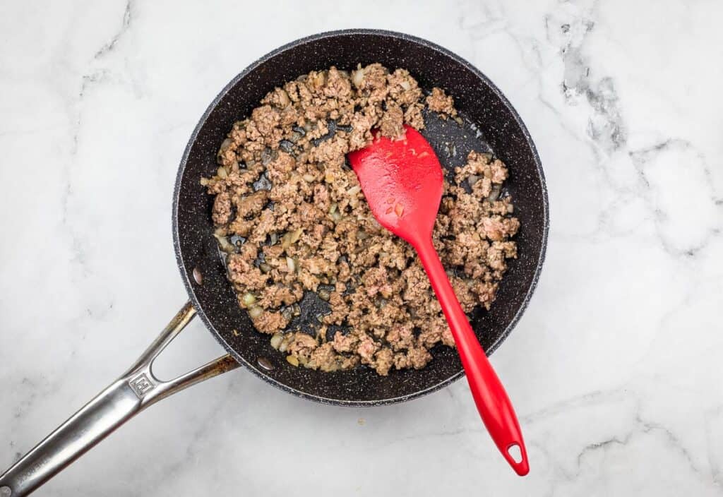 Browned beef in a skillet to make Shepherd's Pie Bites.