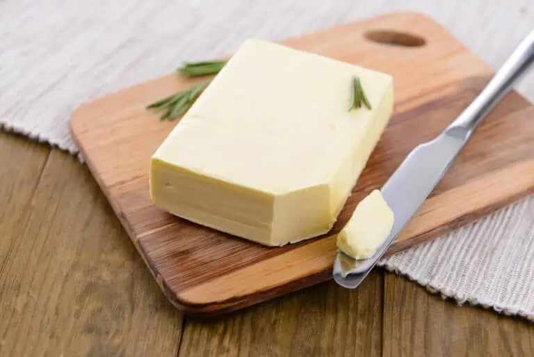 A block of butter with a knife.
