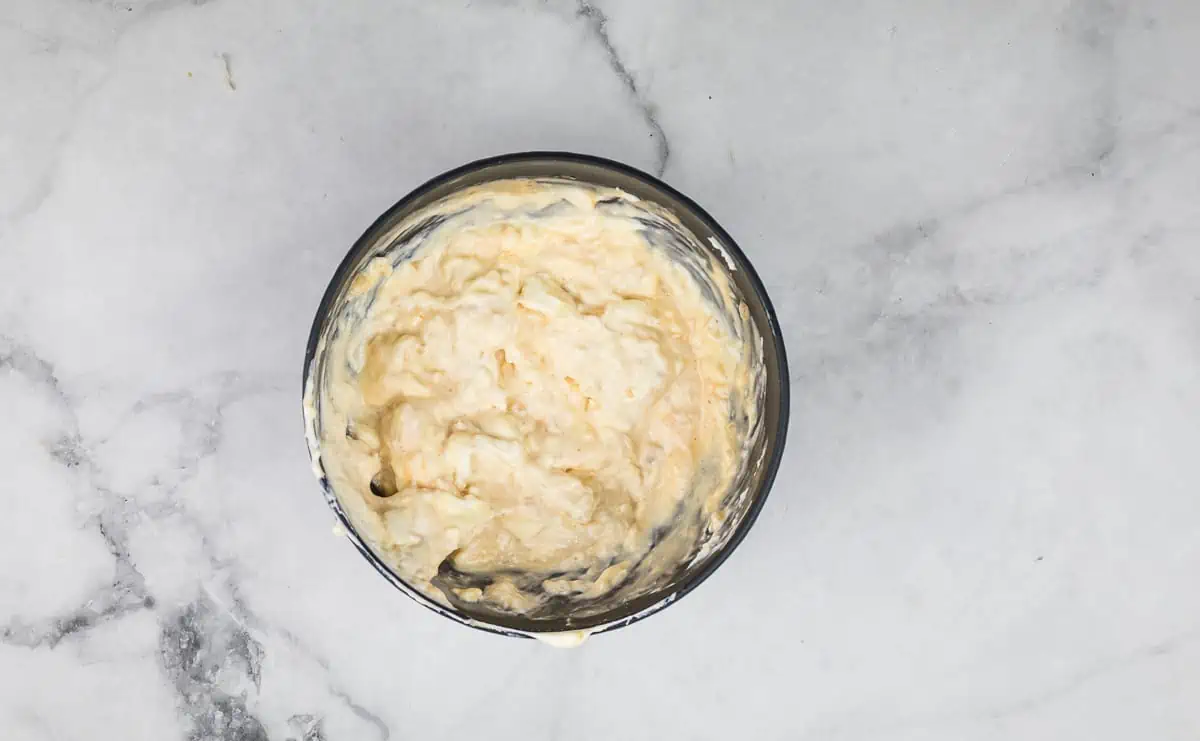 Mixed cream cheese, dressing, and horseradish in a bowl.