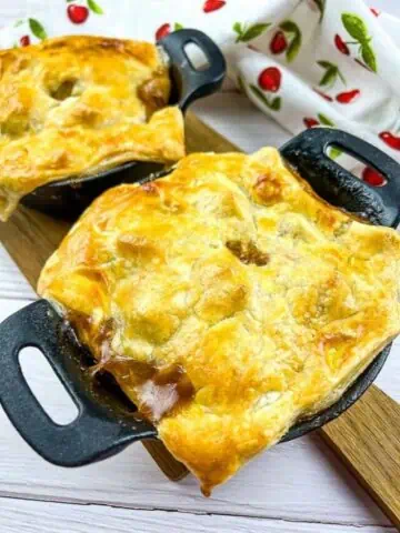 Two Leftover Roast Beef Pot Pies on a board.