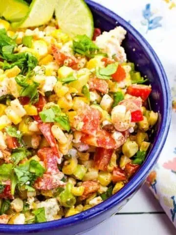 Mexican street corn salad in a blue bowl.