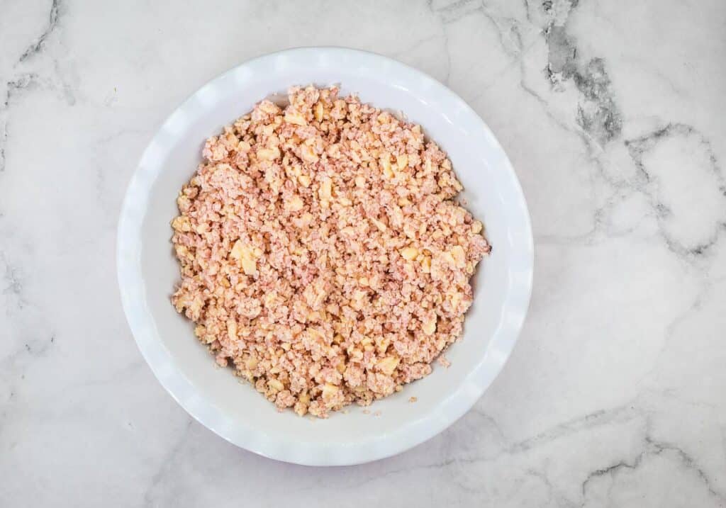 Ham and cheese mixture in a pie dish.