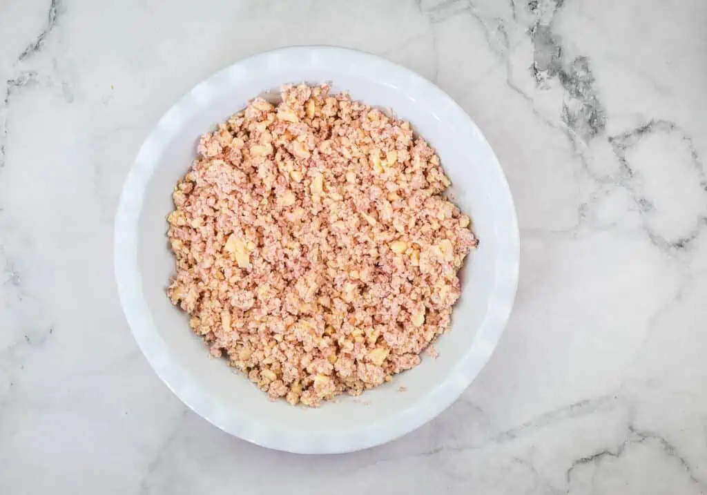 Ham and cheese mixture in a pie dish.