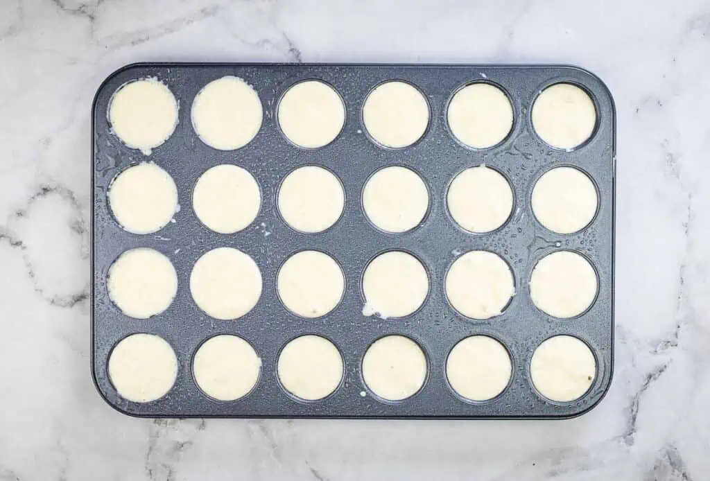 Muffin tin topped up with batter.