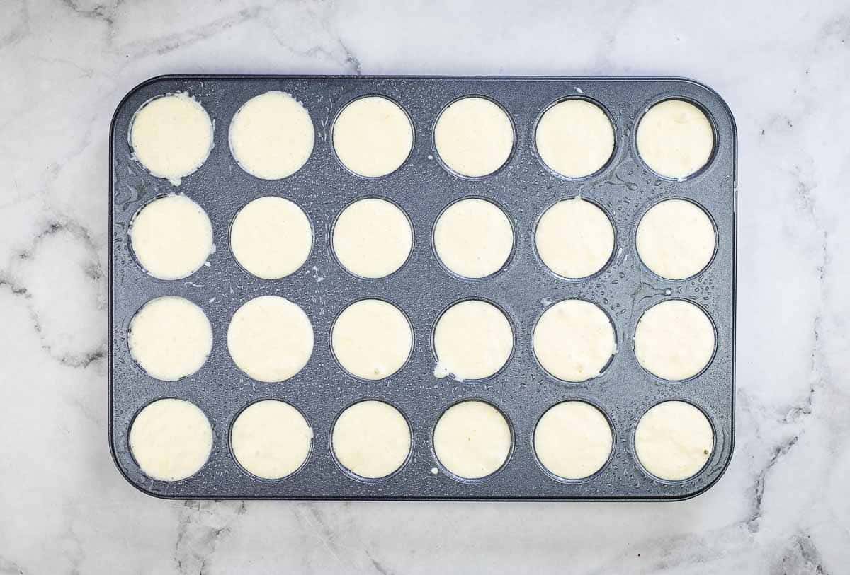 Muffin tin topped up with batter.