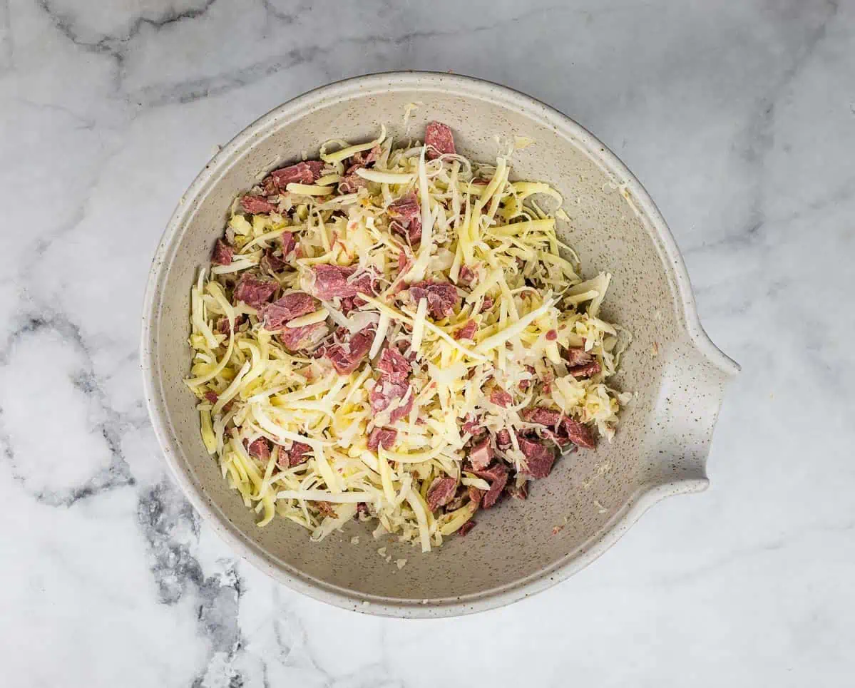 A bowl with the corned beef, cheese, and sauerkraut mixture.