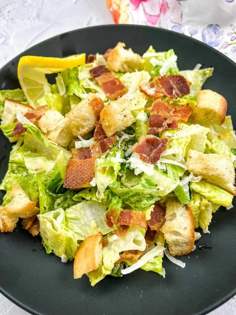 Caesar Salad with homemade dressing in a black bowl.