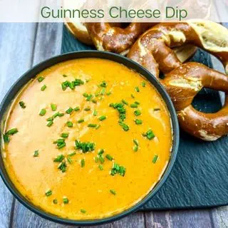 Guinness Cheese Dip with pretzels in the background.