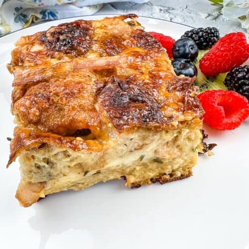 Hot Cross Bun Breakfast Casserole on a white plate with berries.