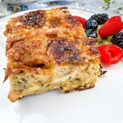 Hot Cross Bun Breakfast Casserole on a white plate with berries.