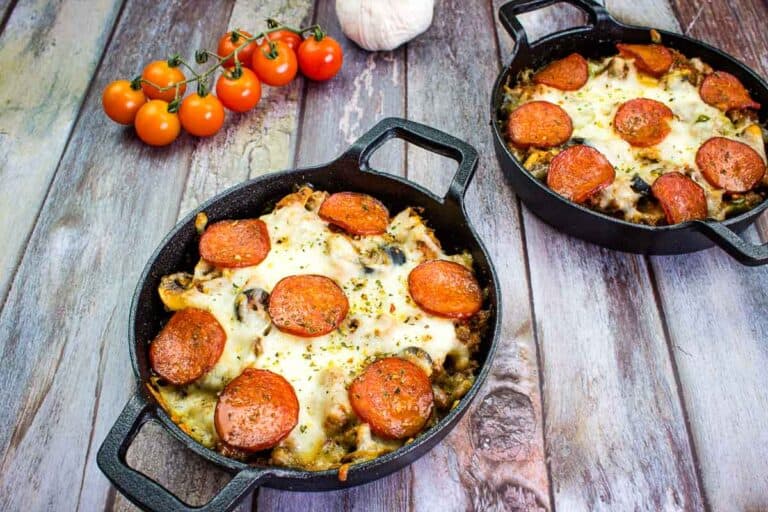 Two servings of pizza casserole in black bowls.