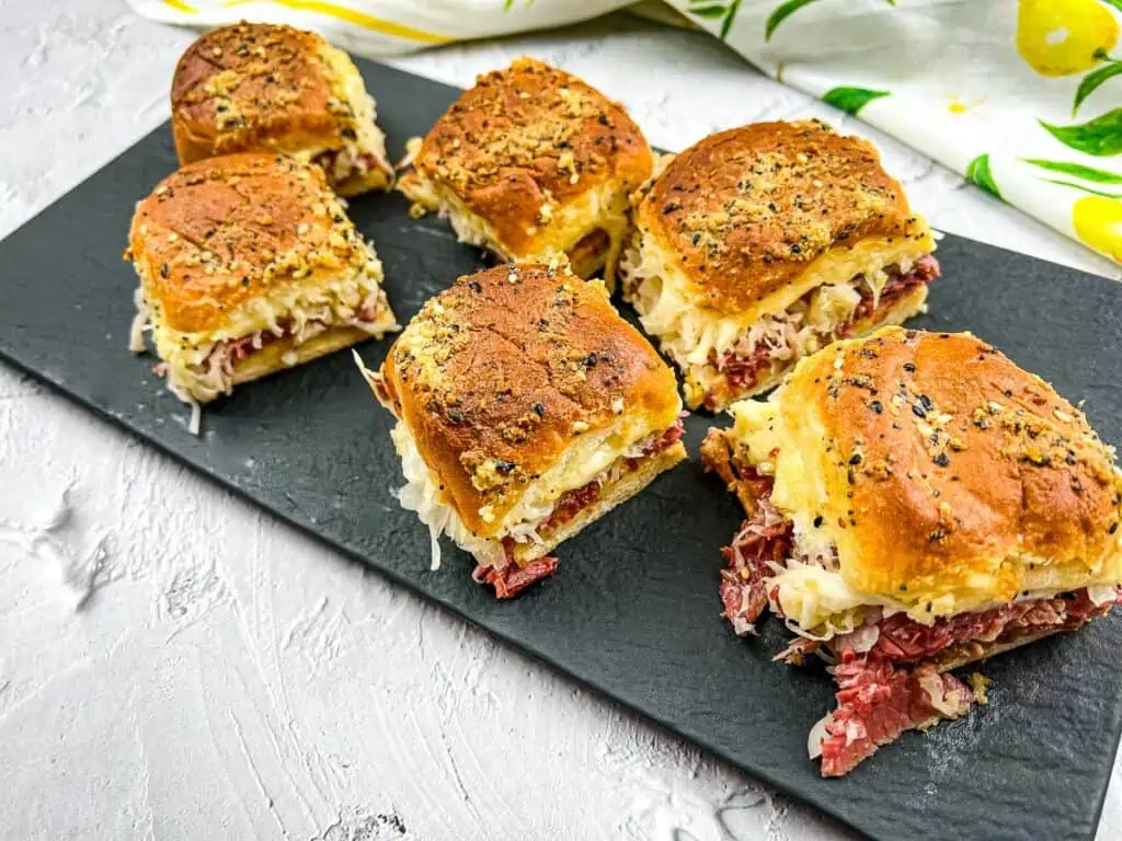 A horizontal shot of sliders on a black platter.