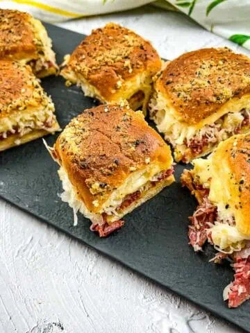 A horizontal shot of sliders on a black platter.