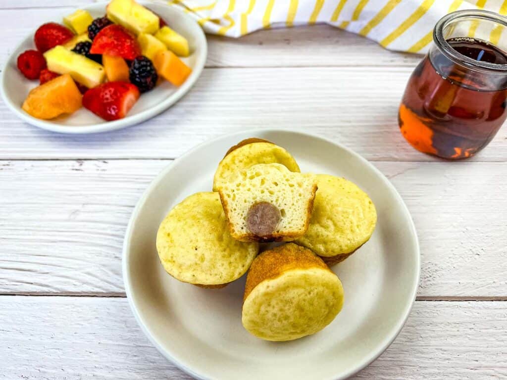 Finished Pancake and Sausage Bites on a plate with fruit.