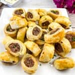 Puff pastry sausage rolls on a square plate.