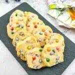 Easter shortbread cookies with mini m&ms on a black plate.