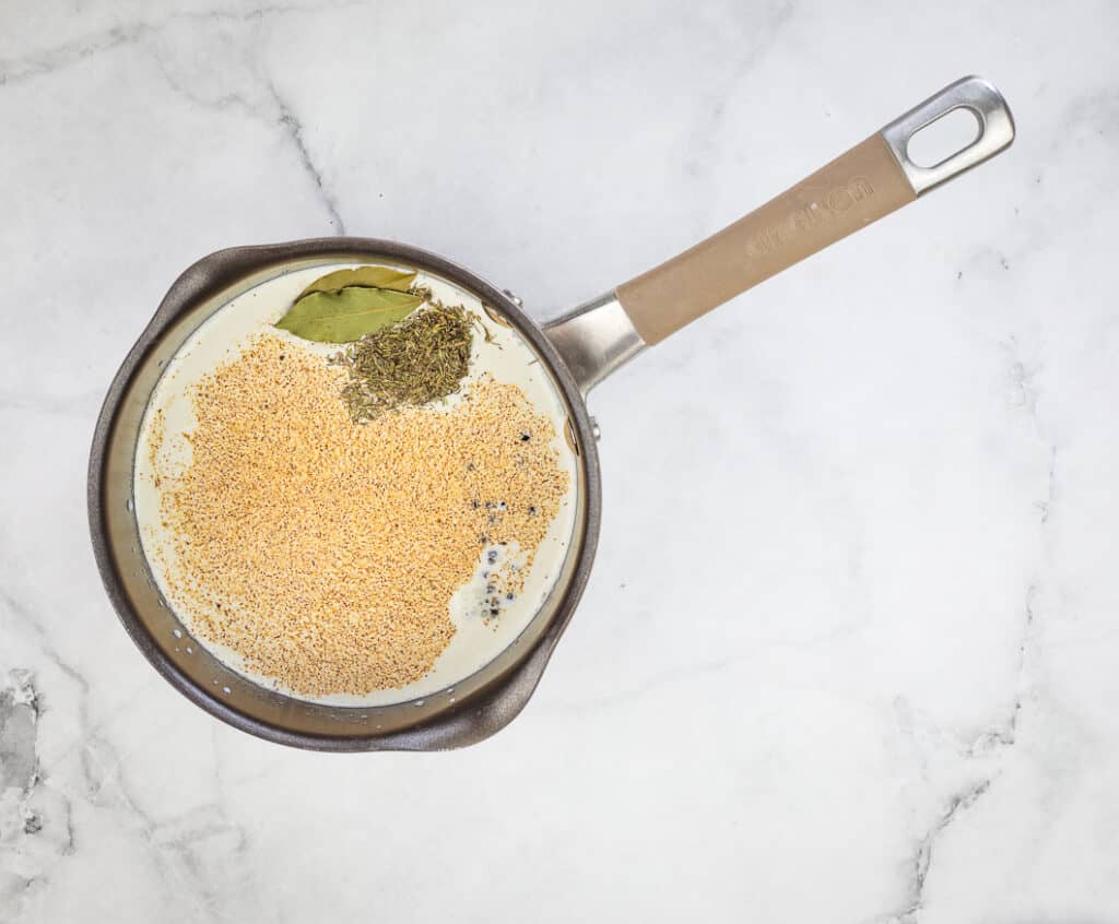 Steep the milk and cream with the spices.