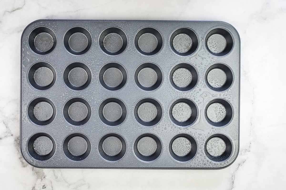 A mini muffin tin sprayed with nonstick cooking spray.