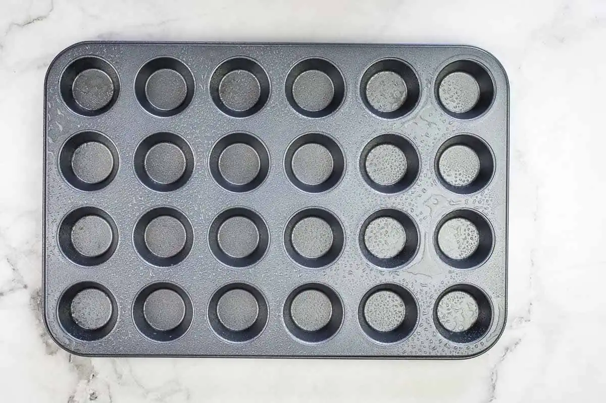 A mini muffin tin sprayed with nonstick cooking spray.