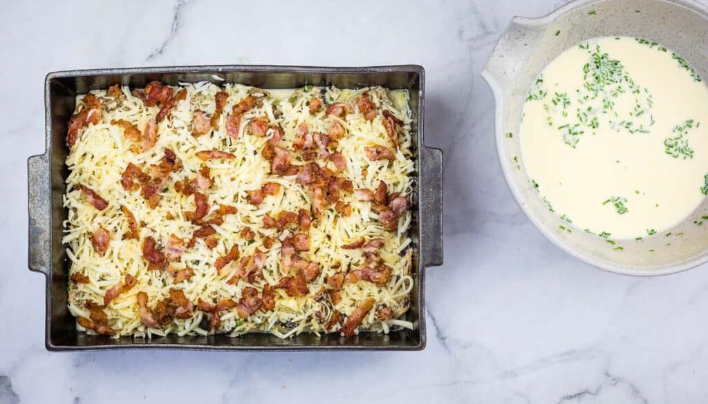 Casserole topped with cheese and bacon.