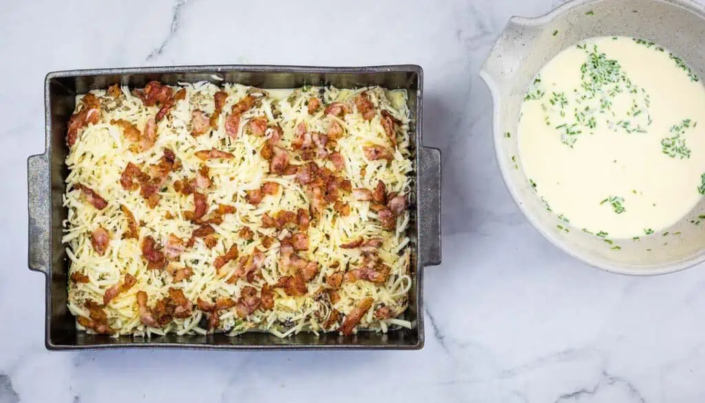 Casserole topped with cheese and bacon.