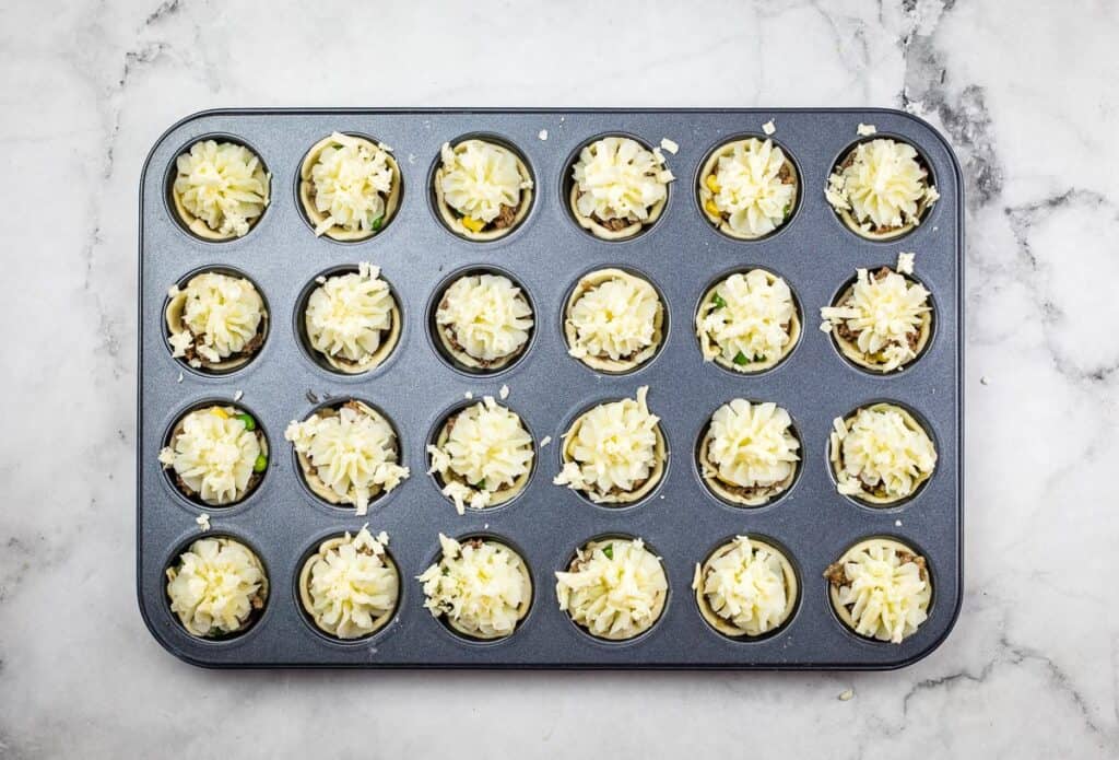 Potato and cheese added to the mini Shepherd's Pie Bites in the tin.