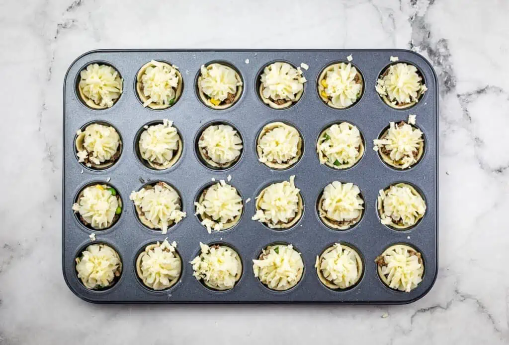 Potato and cheese added to the mini Shepherd's Pie Bites in the tin.
