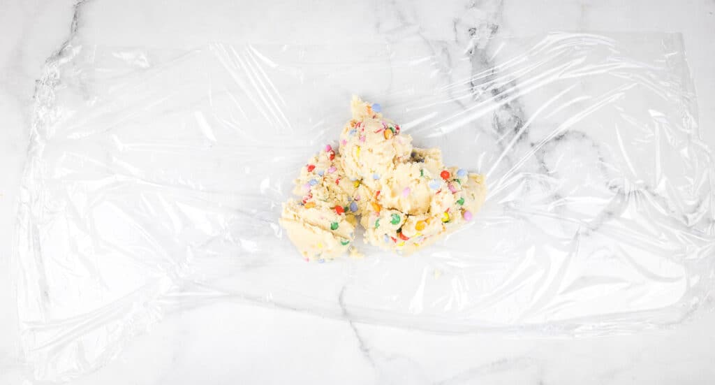 Dough turned out onto plastic wrap.
