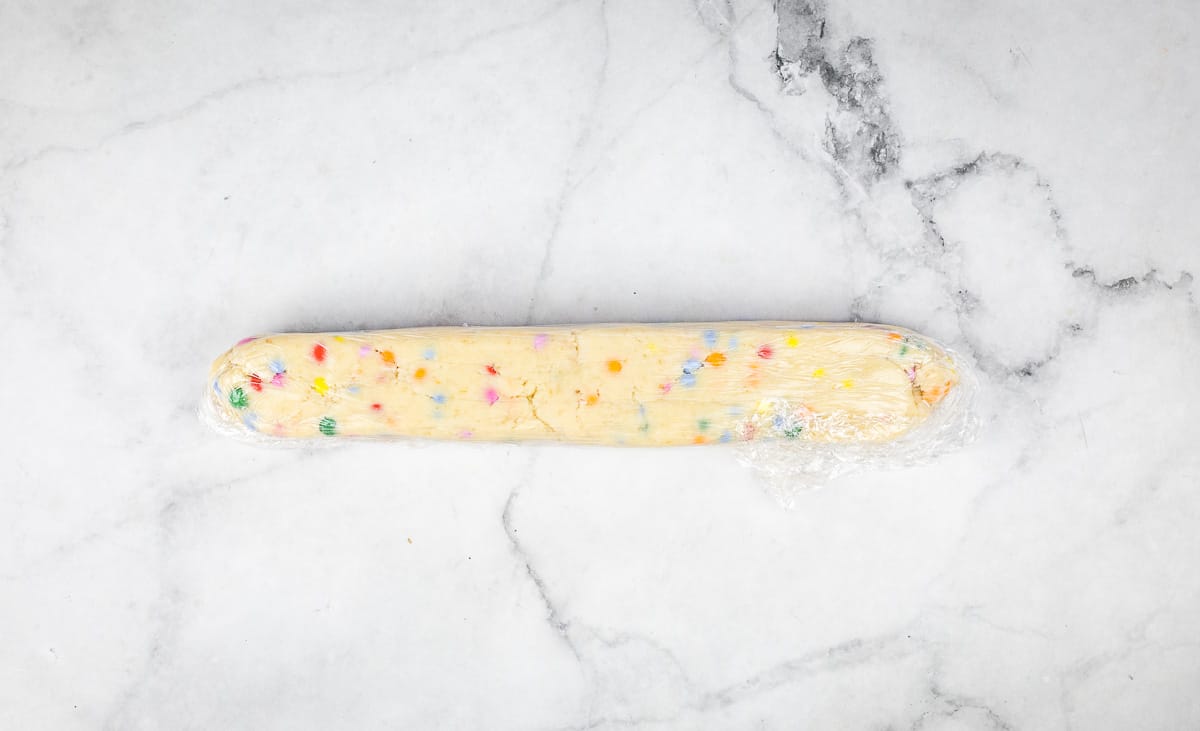 A shortbread log wrapped in plastic.