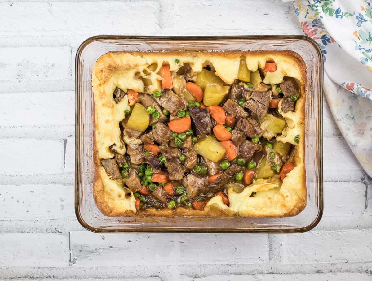 Yorkshire pudding pie in a white glass dish.