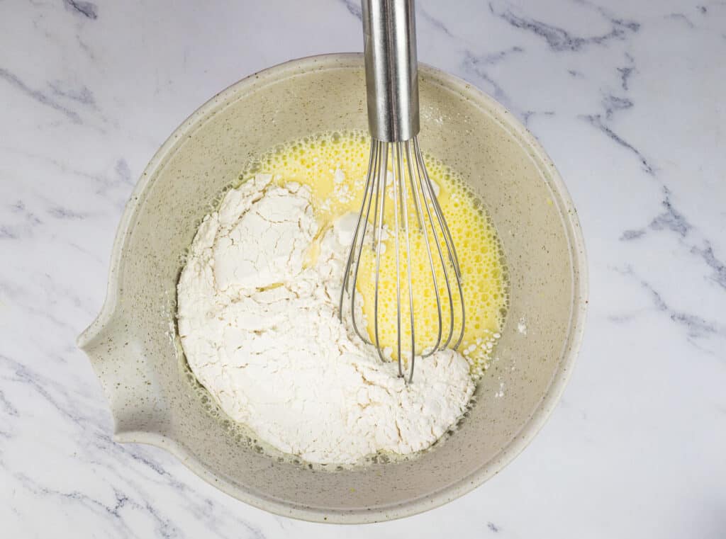 Flour added to the milk and eggs.