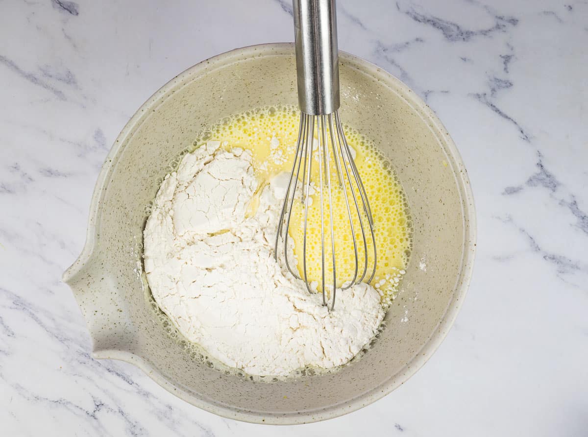 Flour added to the milk and eggs.