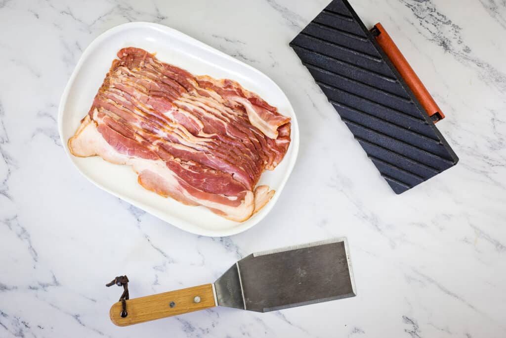 Tools to make bacon on a Blackstone Griddle.