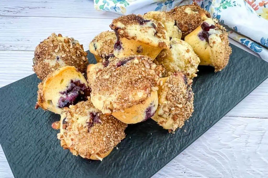 Mini Blueberry Muffins on a black platter.