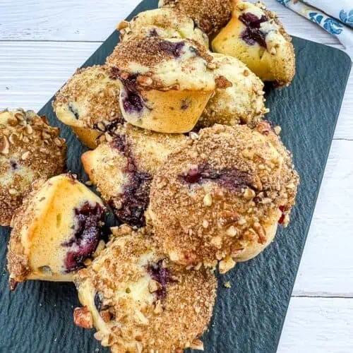 Mini Blueberry Muffins on a black platter.