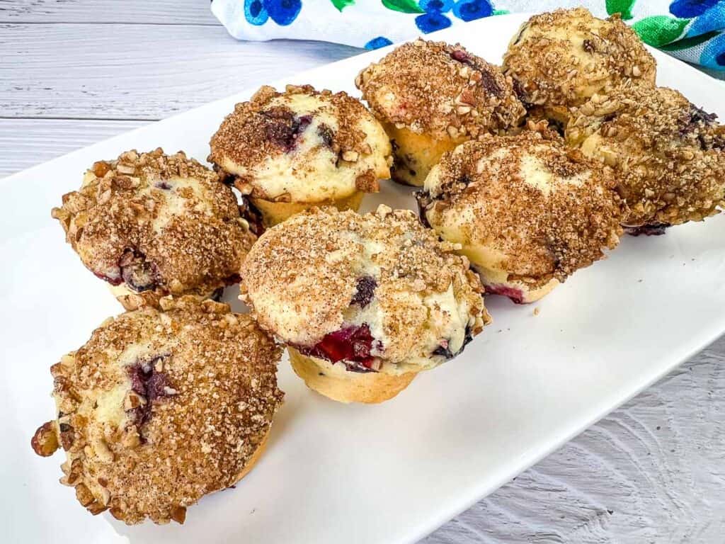 Mini Blueberry Muffins with Pecan-Cinnamon Crumble on a white platter.