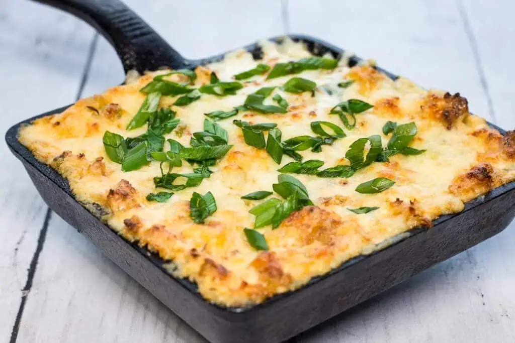 Crab Rangoon Dip in a black cast iron dish.
