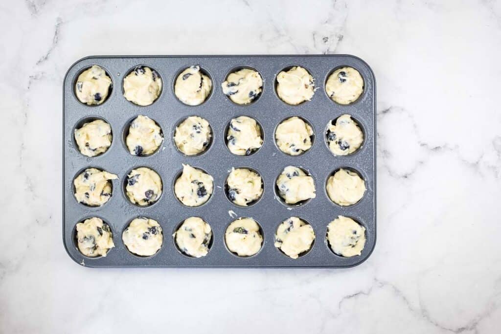 Muffin tin filled with batter.