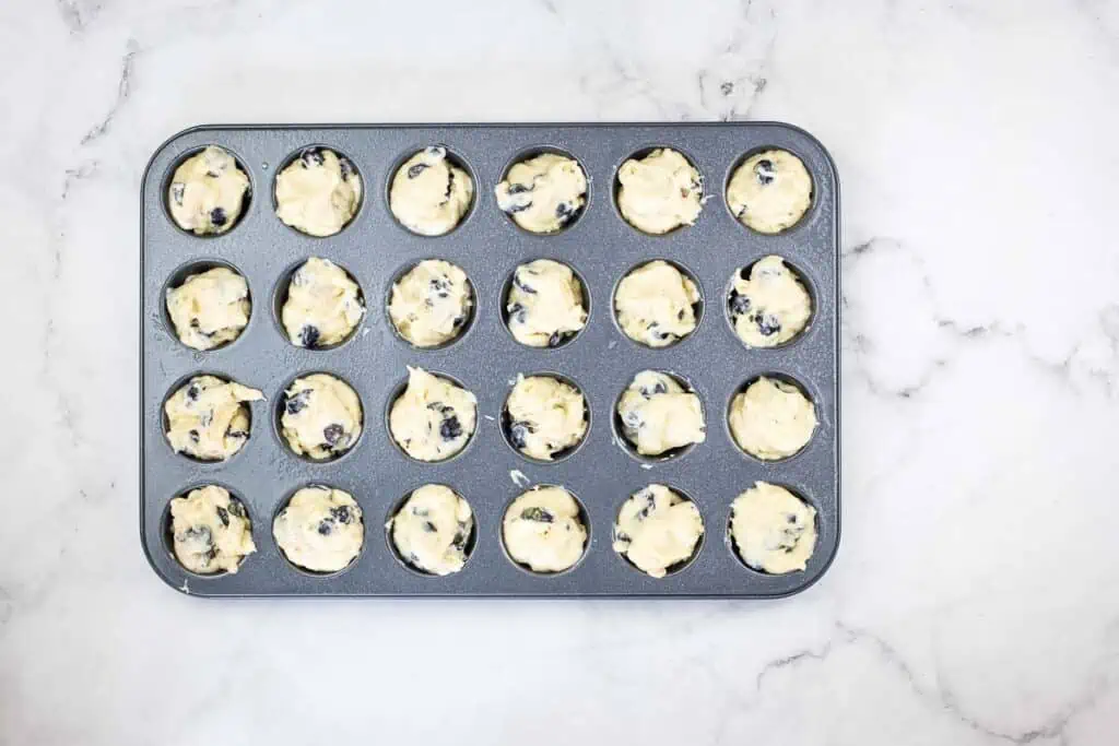 Muffin tin filled with batter.