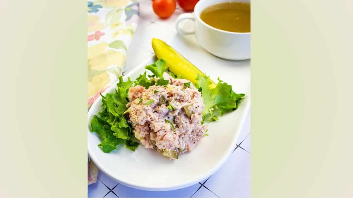 Ham Salad with dill pickle on a plate.