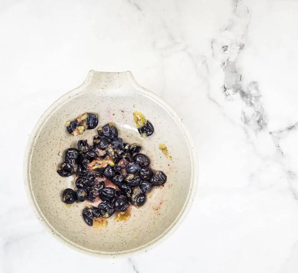 Smashed blueberries in a bowl.