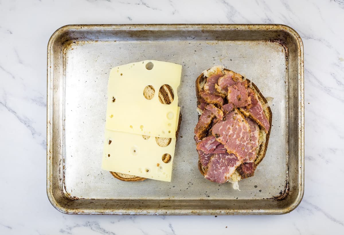 Open faced sandwich on a baking sheet.