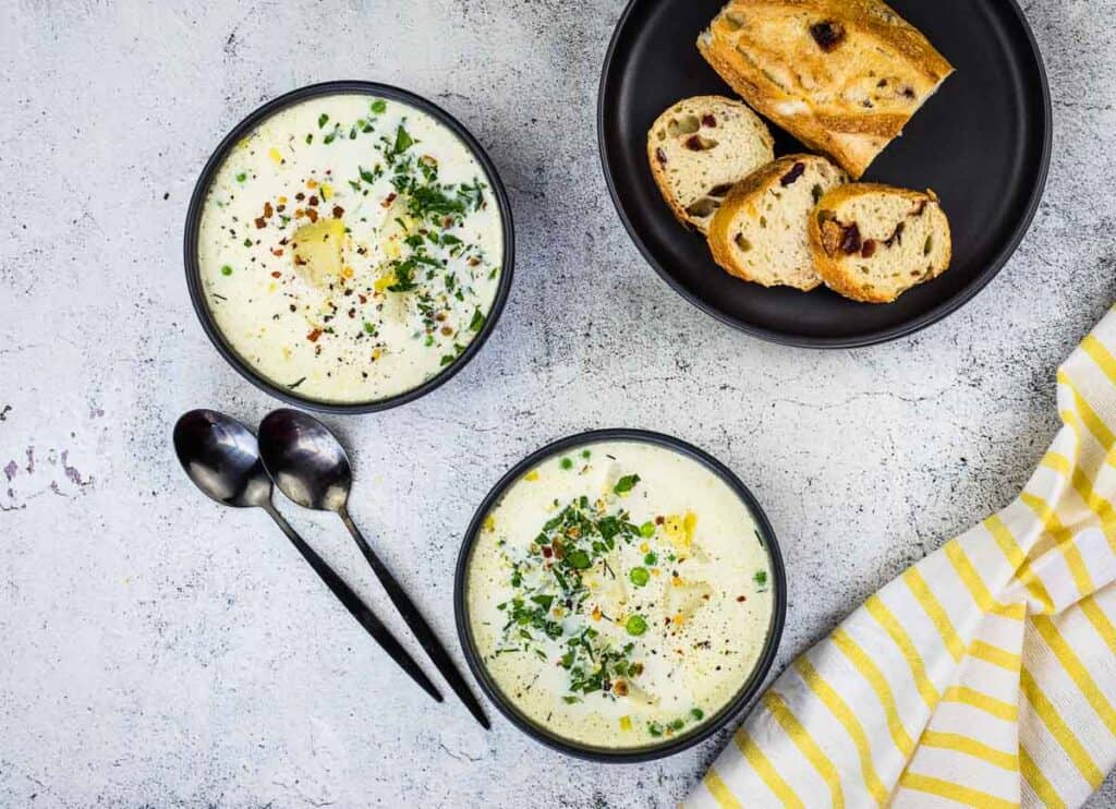 Finished Potato & Pea Chowder in two black bowls.