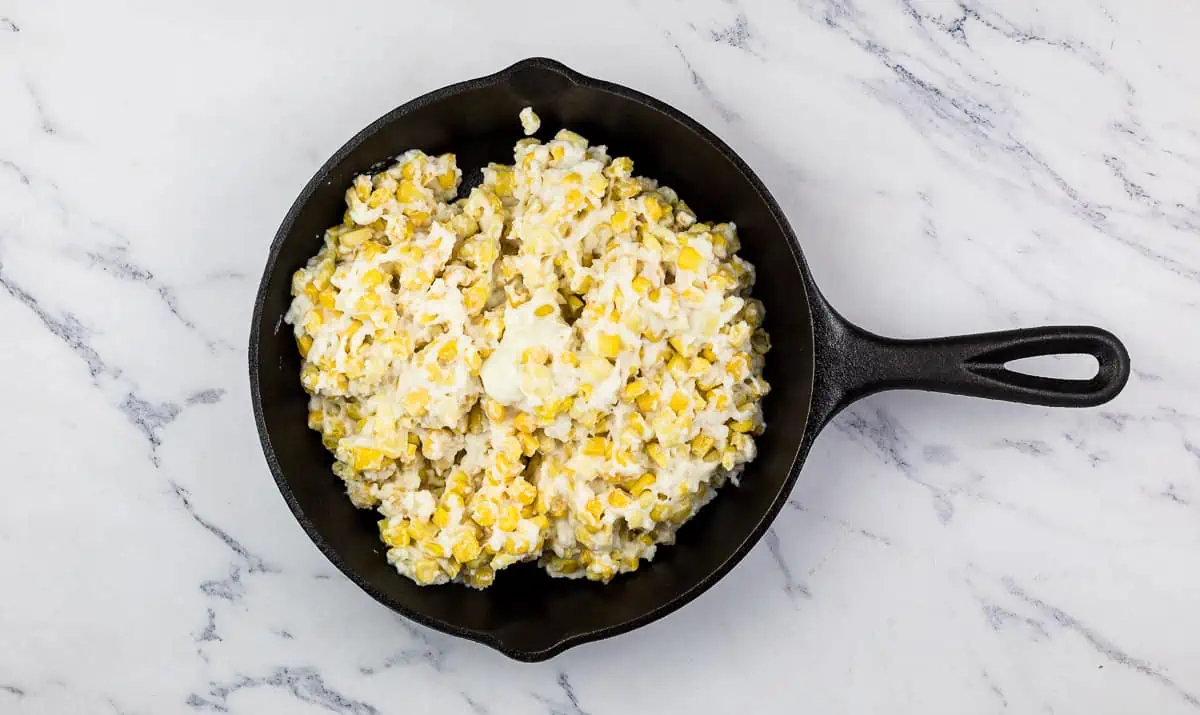 Creamed corn in a skillet ready to go onto the smoker.