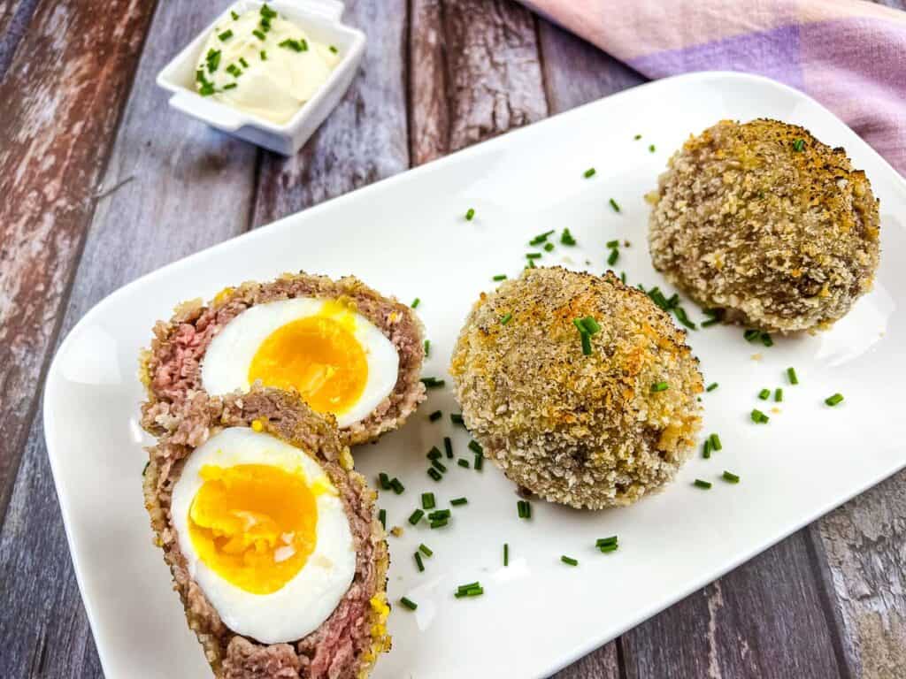 Keto Scotch Eggs on a white platter.