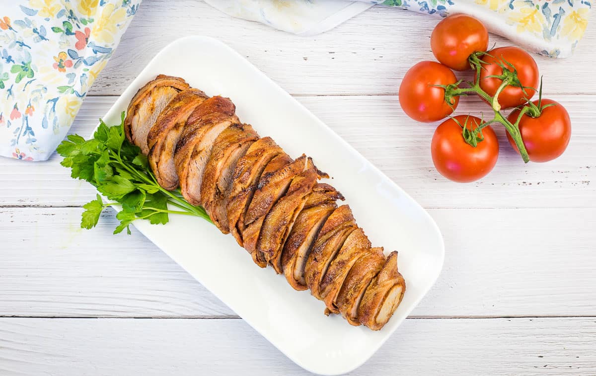 Smoked ham on a wooden cutting board.