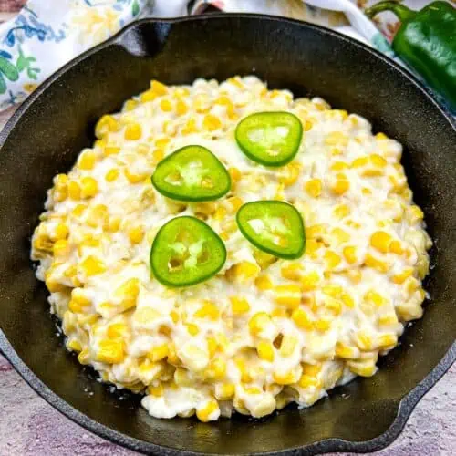 Smoked creamed corn in a black skillet.