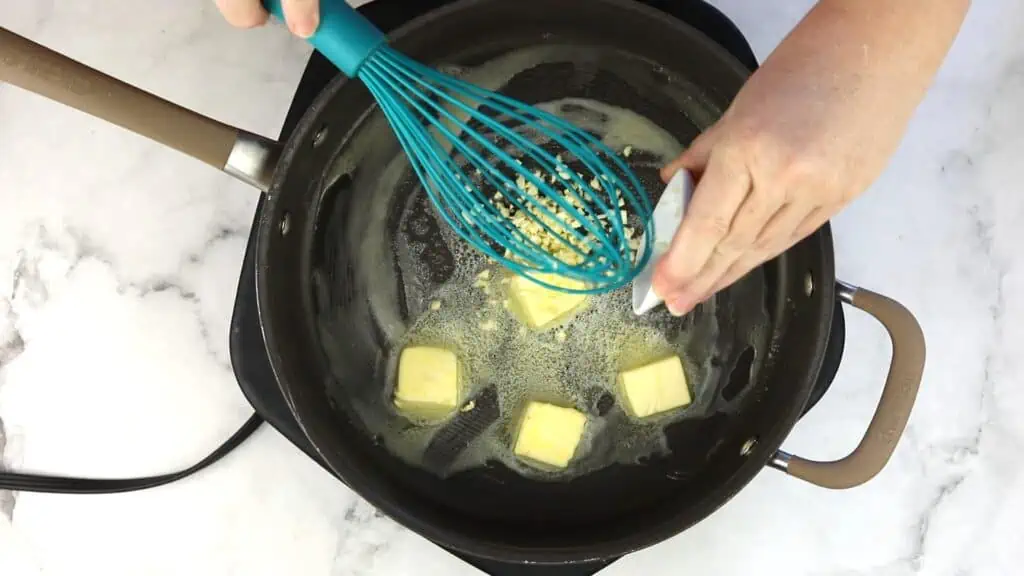 Melting the butter and cooking the garlic.