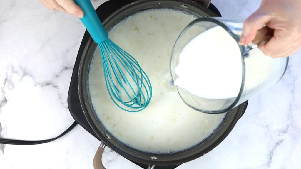 Adding the milk and thickening the sauce.